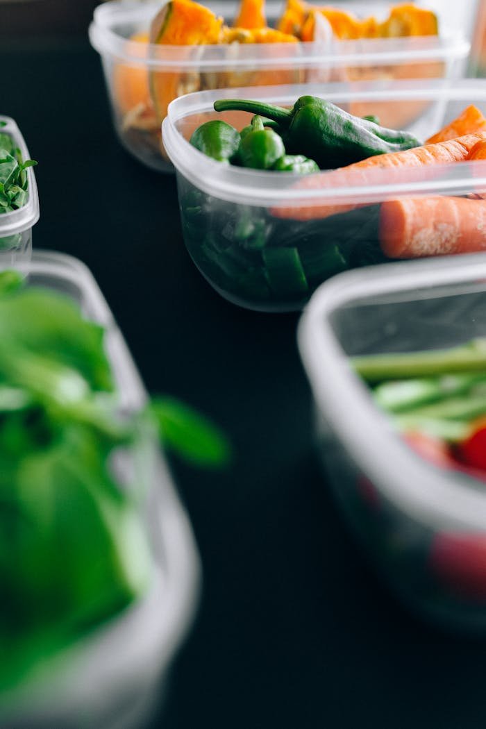 about-02 Close-up view of assorted fresh vegetables stored in plastic containers preserving freshness.